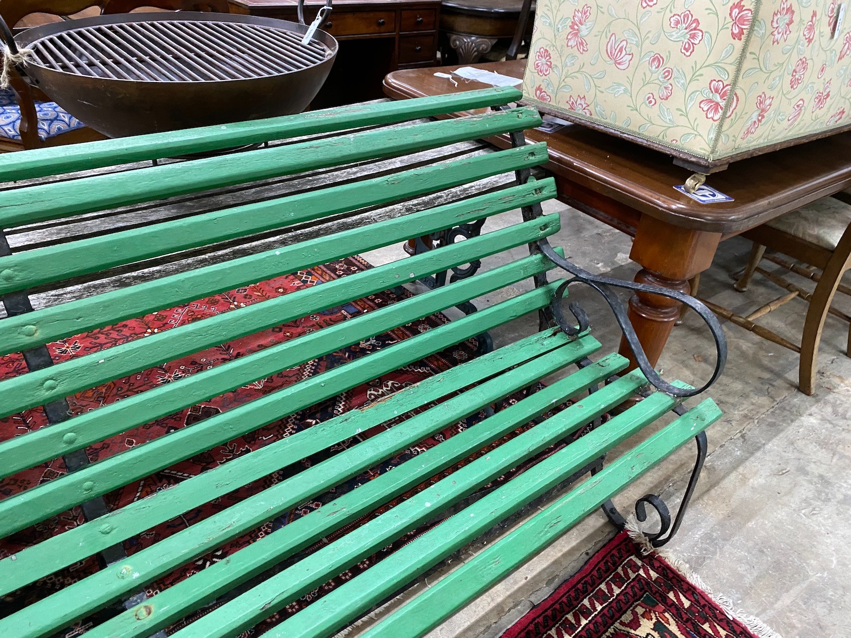 A wrought iron painted slatted wood garden bench, length 213cm, width 70cm, height 86cm